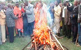 The flames of a bonfire near a Chuch in Nigeria consume the idols formerly worshipped by a young Nigerian man.